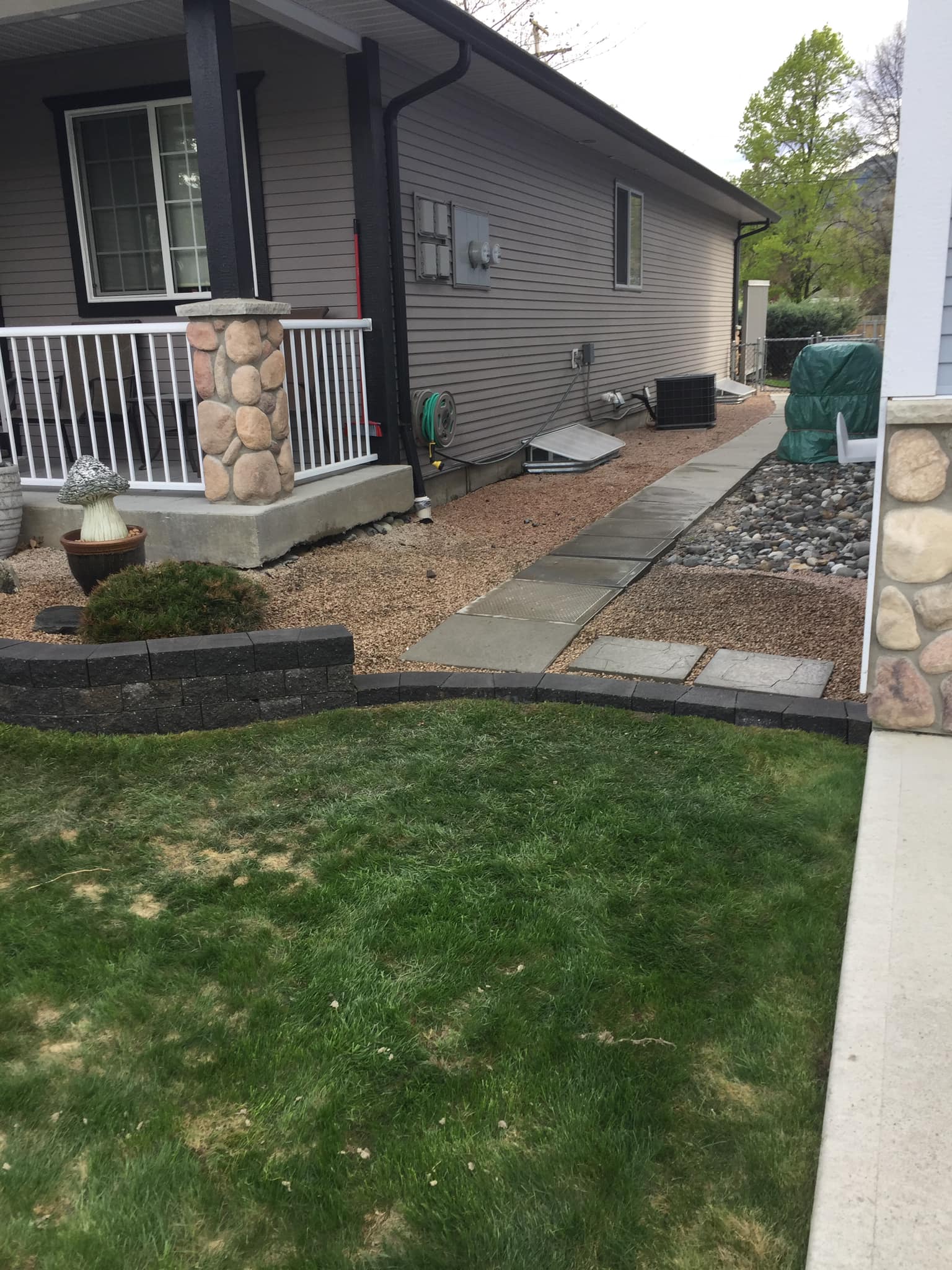 Mature landscaping at a Kamloops home with planting beds and trees