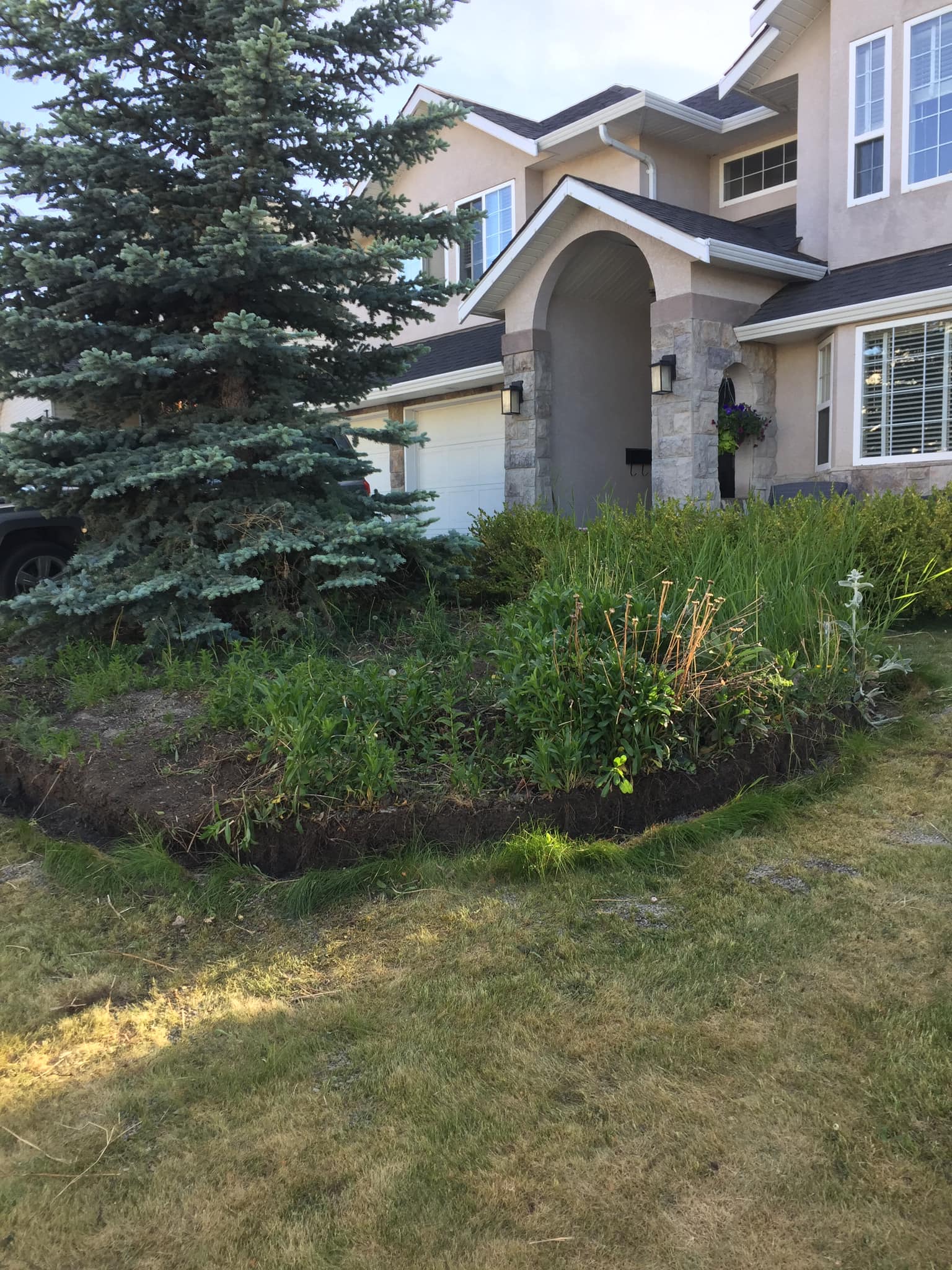Mature Kamloops landscaping with stonework
