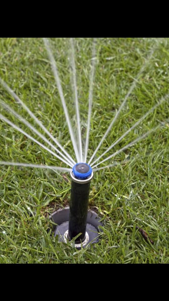 Rotor sprinkler watering a Kamloops lawn